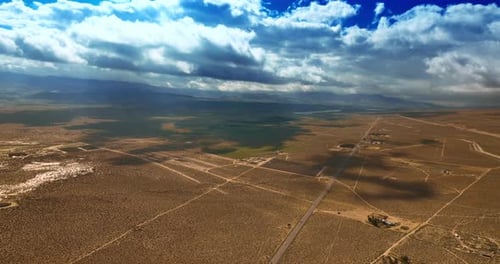 Fantastic cloudscape hanging over the desert and throwing shadows on the land.
