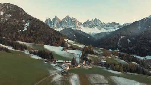 Flying over Santa Maddalena village (St Magdalena) in Dolomites mountains, Italy