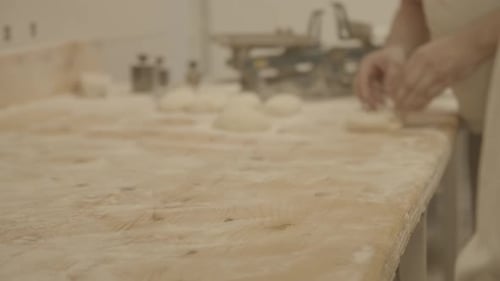 Making bread in the bakery. Blackmagic camera. A baker makes bread.