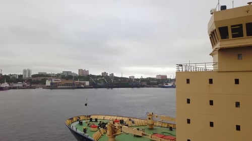 A Beautifully Serene Harbor View Featuring a Vessel Docked Nestled Amidst Nature and Industry Stock