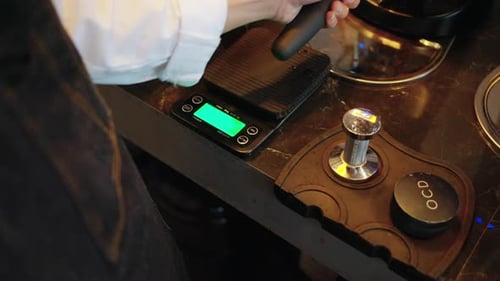 4K Barista making hot coffee on coffee maker at coffee shop.