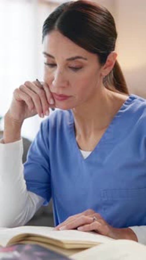 Nurse, woman and books with studying in home for medical research, nursing guide