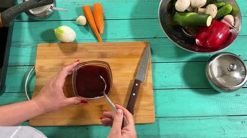 Woman Mixing Sauce Overhead Shot with Fresh Ingredients