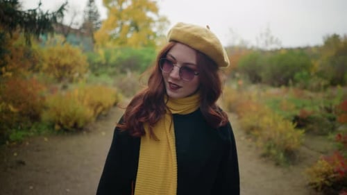 Stylish Autumn Walk Lady Adjusts Hair in Yellow Beret