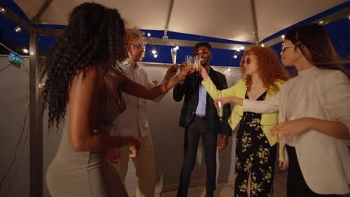 Friends Toast Champagne at Fun Rooftop Party