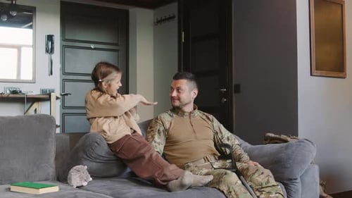 Smiling Girl Talking to Man on Living Room Couch