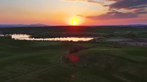 Sunset Wavy Hills with Fields and Pond