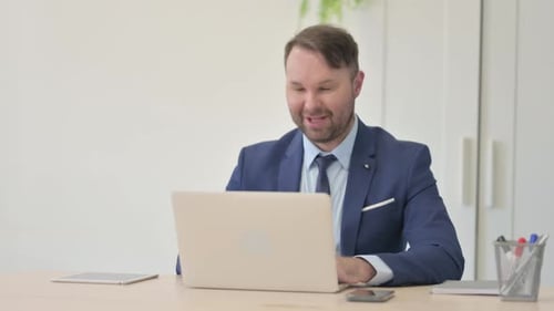Man in Suit Chatting in Video Conference