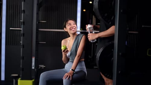 Couple of Man and Woman Exercising at Modern Gym Center