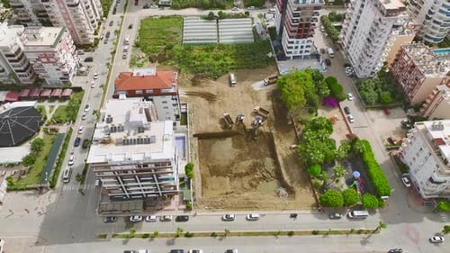 Site Clearing Aerial of Excavators and Trucks at Real Estate Project