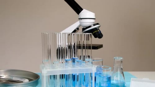 Microscope, Test Tubes, and Beakers in Laboratory