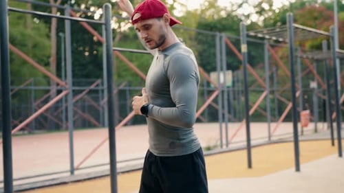 Fit Man Stretching at an Outdoor Workout Park