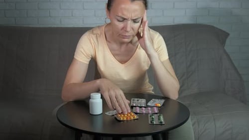 Woman Struggling With Headache Seated at Home