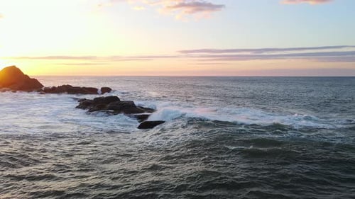Raging Sea in the Morning at Dawn Waves Roll on the Rocky Shore Spray Soars Into the Sky