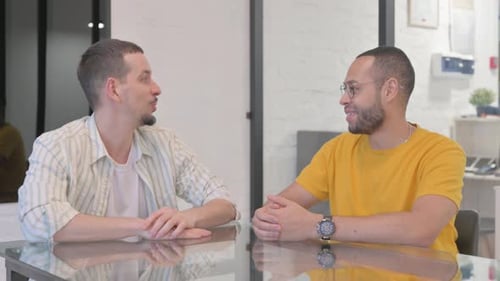 Creative Man Talking with Male Worker in Office