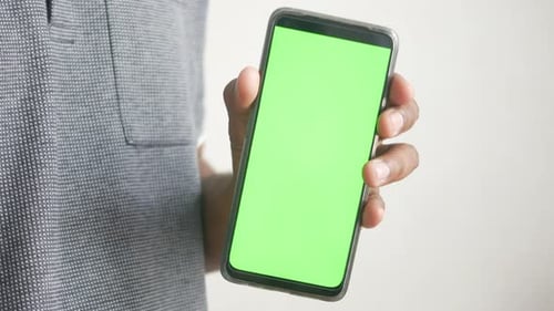 Close Up of Young Man Hand Using Smart Phone with Green Screen