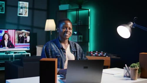 Portrait of Happy Woman Sitting at Home Office Desk in Front of Laptop