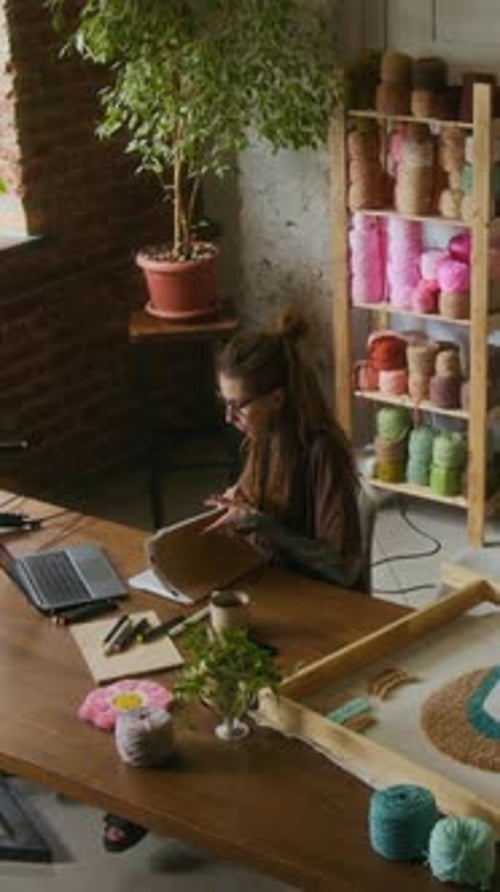 Rug Making Studio with Female Artist using Laptop Vertical