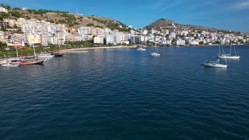 Boats and Yachts Line the Pier, Hotels Nestle Down the Hills, Offering Captivating Sea Views in the