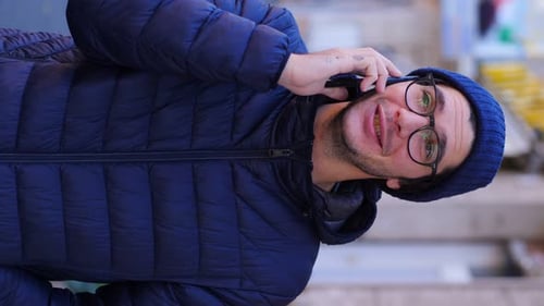 Young Man Talking on Phone in Urban Setting
