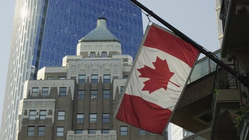 Canadian Flag Waving Downtown in Cityscape