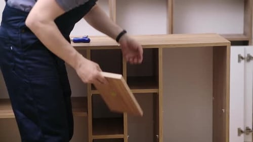 Furniture Shipping and Fixing Carpenter Putting Wooden Shelves on Rack in Office