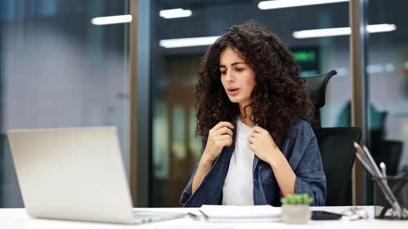 Overworked Businesswoman Suffers Hot Flash at Desk in Modern Office ...