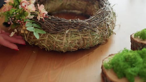 Close Up of Floral Wreath Being Decorated