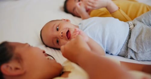 Three Children Playing on Bed Together
