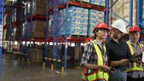 Blue collar workers working at warehouse.