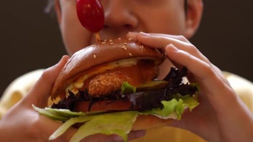 Child Eating Big Burger Close Up