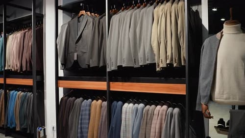 Strict Premium Expensive Luxury Suits Hang in a Row on Hangers in Large Quantities Business Suit