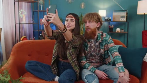 Couple Waving During Video Call on Phone Indoors
