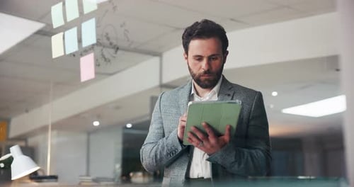 Man in office works on tablet technology