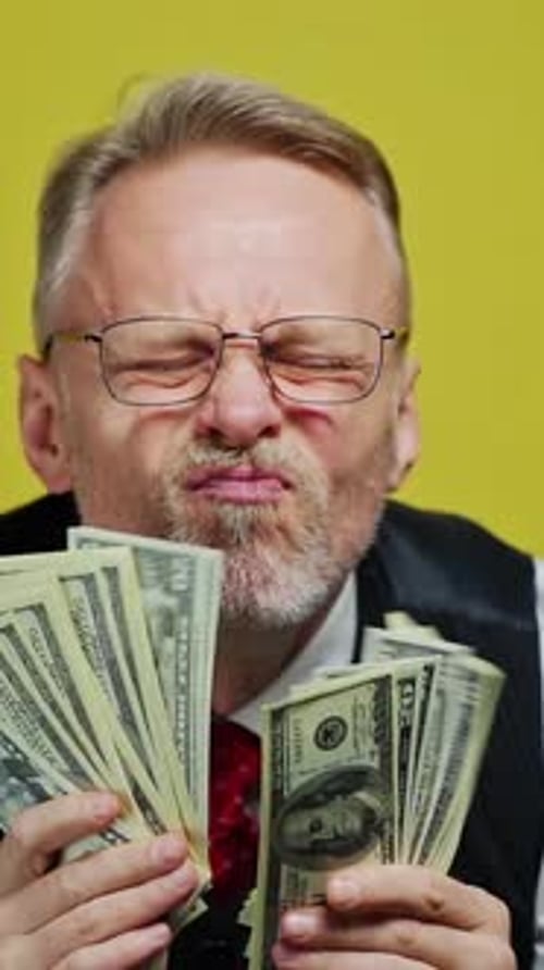 Adult Holds Fans of Dollar Bills, Sticks Out Tongue