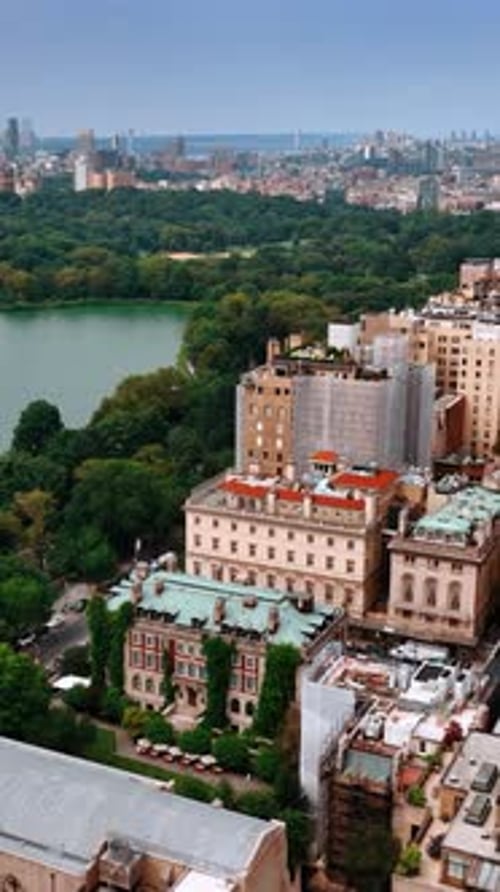 Footage over the tops of residential houses surrounding the beautiful Central Park.