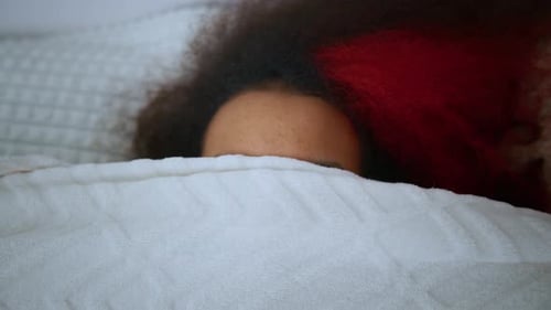 Young Adult Woman Relaxing in Bed