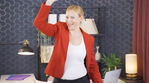 Happy Woman Dancing in Office After Achieving Success