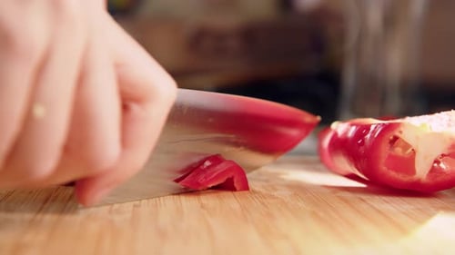 Top Down View Female Hands Cut Red Fresh Pepper on Board Closeup