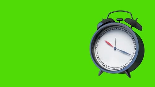 Classic Black Alarm Clock on Green Background