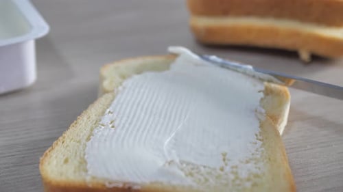 Cream Cheese Being Spread Onto Toast