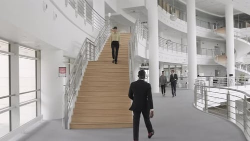 Business People Walking in Large Modern Office Building