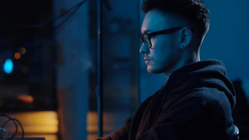 Conceito de crime cibernético, hacking e tecnologia - hacker asiático masculino usando óculos