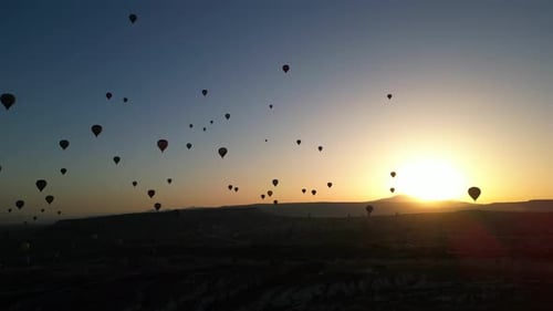 Majestic Balloons Drifting at Golden Sunrise