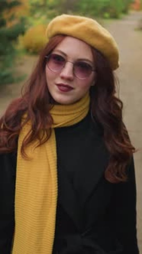 Elegant Lady in Yellow Beret Observes Surroundings in Park