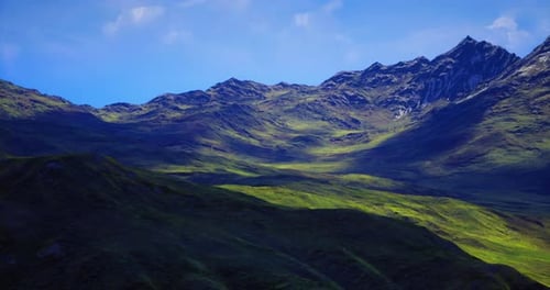 Majestic Mountains Under Clear Blue Sky with Lush Green Valleys