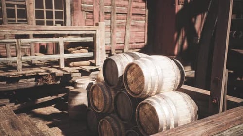 Wooden Barrels Stacked in a Rustic Warehouse During the Afternoon Light