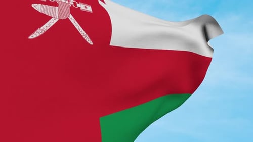Waving Flag of Oman Against Blue Sky