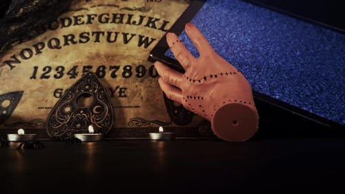 Halloween themed table with ouija board and candles