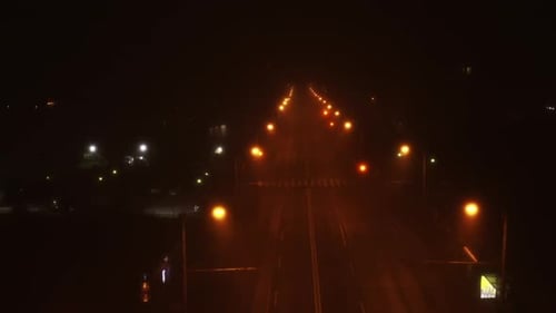 Spooky road and street lights at night with an empty road. Romania, Cluj-Napoca, Romania. Foggy nigh